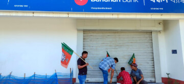 Cooch Behar: BJP workers place party flags on the gate of a closed Bandhan Bank during a 12-hour Bengal strike in protest against alleged police brutality during the Navanna campaign yesterday, and to demand the resignation of West Bengal Chief Minister Mamata Banerjee, in Cooch Behar on Wednesday, August 28, 2024. (Photo: IANS/@BJP4Bengal)